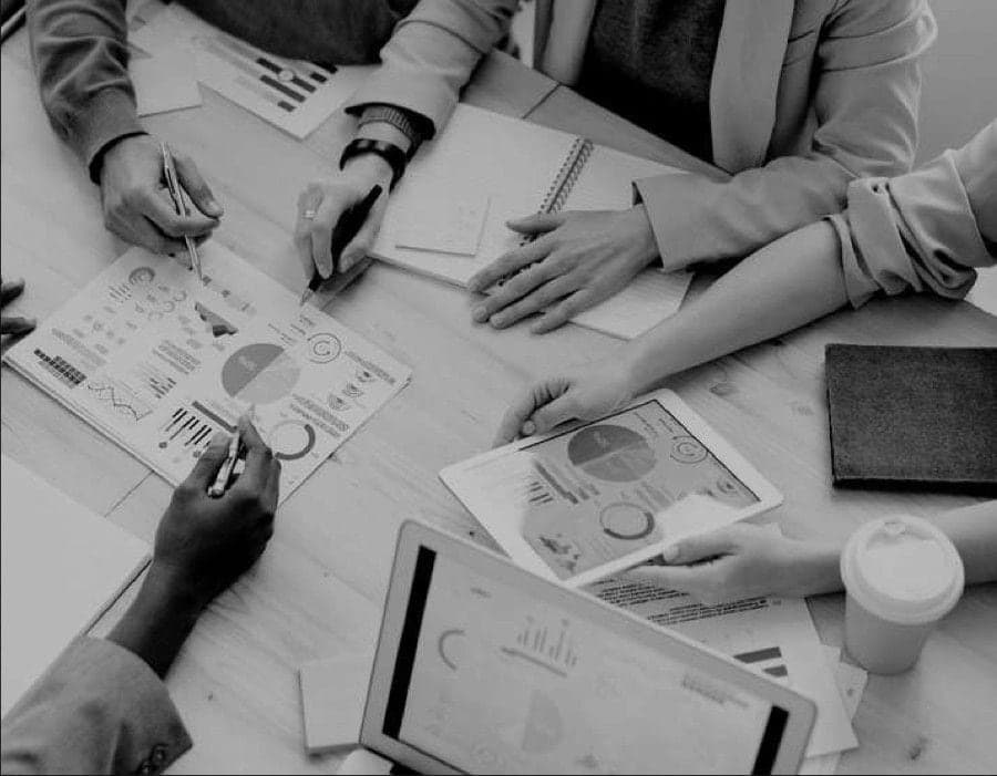 Black-and-white photo of advisers working over charts